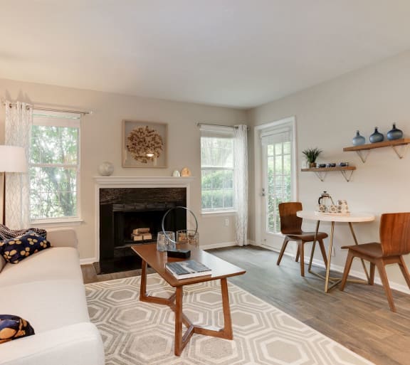 a living room with a couch and a table and a fireplace at Madison at Eden Brook, Columbia, MD, 21046