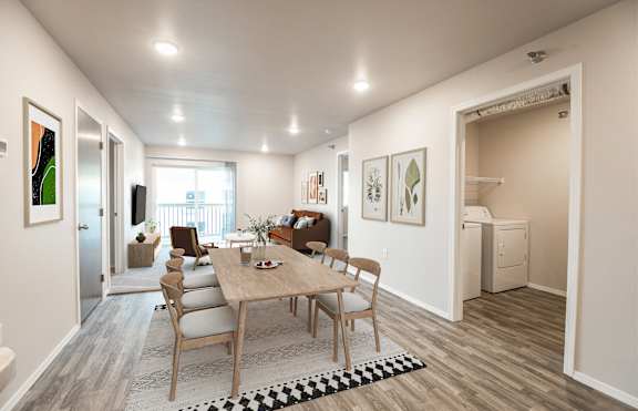 A dining room with a table and chairs.