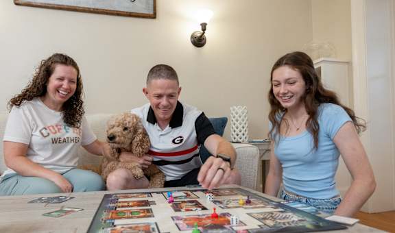 A family playing a board game together in their living room.