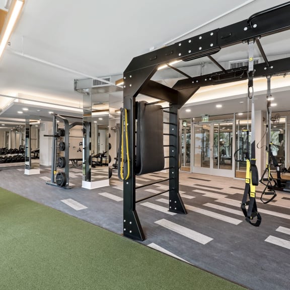 a gym with weights and exercise equipment in a building