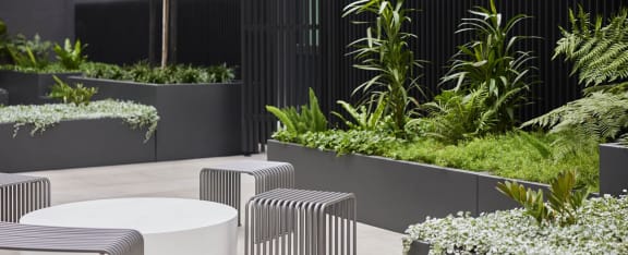 an outdoor seating area with tables and plants