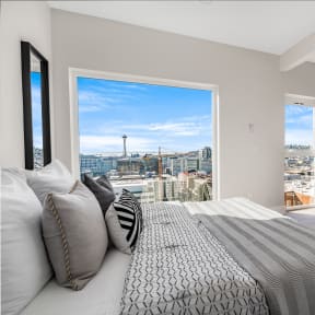 a bedroom with a bed and a view of the city  at Oslo, Seattle, 98102