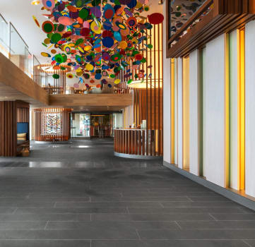 the lobby of a hotel with a large colorful chandelier