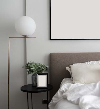 a bedroom with a bed and a lamp