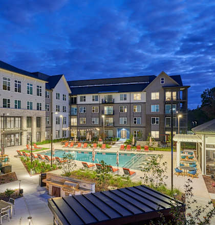 A large building with a pool in the courtyard.