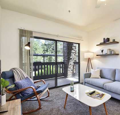 a living room with a couch and a sliding glass door