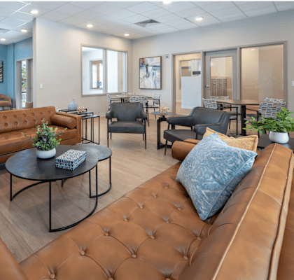 A living room with brown leather couches and a coffee table.