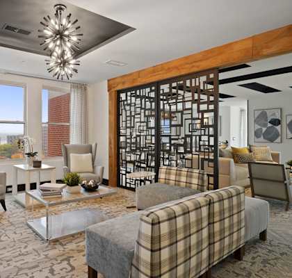 a living room with couches and chairs and a chandelier