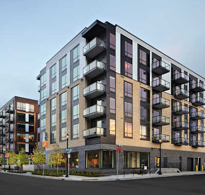 a rendering of an apartment building on a city street