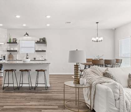 a living room with a kitchen and a dining room