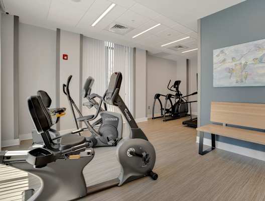 a room filled with exercise equipment and a bench