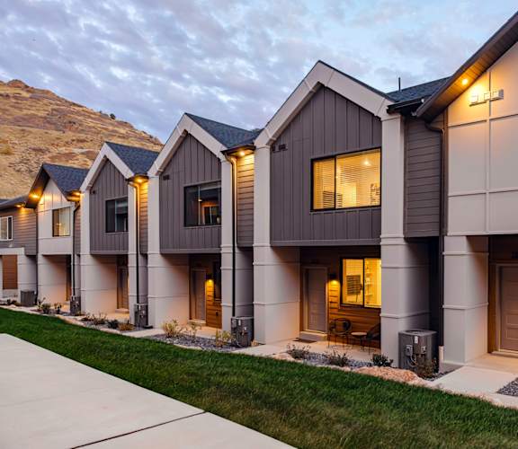 A modern house with a mountain in the background.