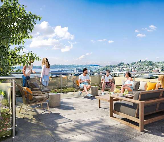 a group of people sitting on a roof terrace with a view of the city