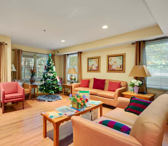 a living room filled with furniture and a christmas tree
