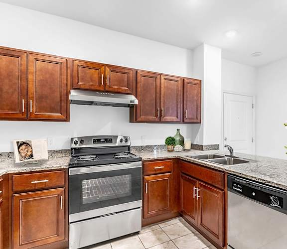 a kitchen with wooden cabinets and stainless steel appliances