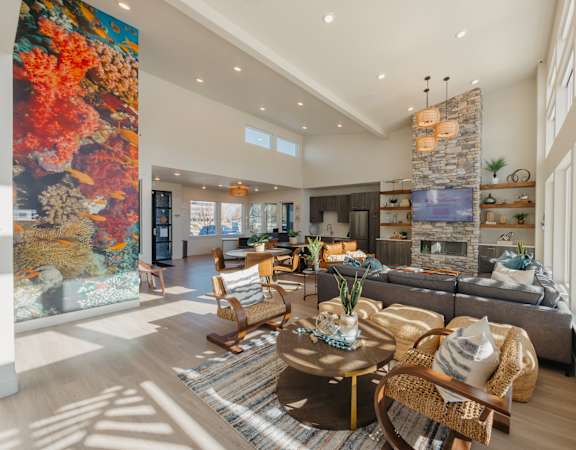 A living room with a large painting on the wall and a fireplace.