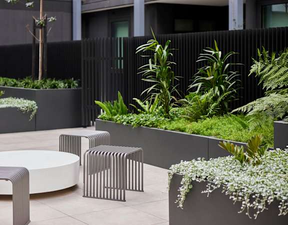 an outdoor seating area with tables and plants