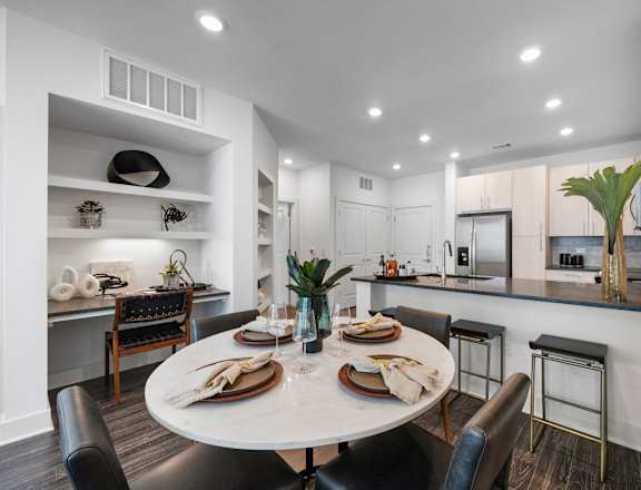 an open kitchen and dining room with a table and chairs