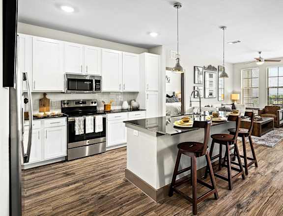 a large kitchen with a center island and a dining area