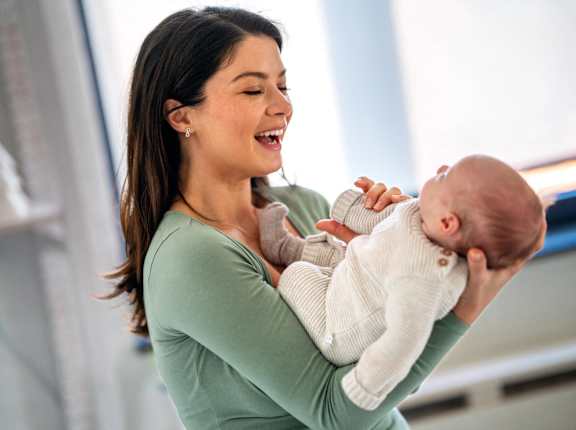 a woman holding a baby in her arms