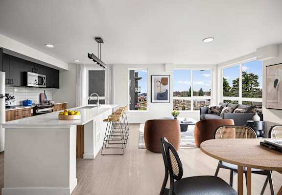 a kitchen and living room with white walls and hardwood floors at Ion Town Center, Washington, 98133