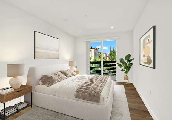 A bedroom with a large bed and a view of the city.