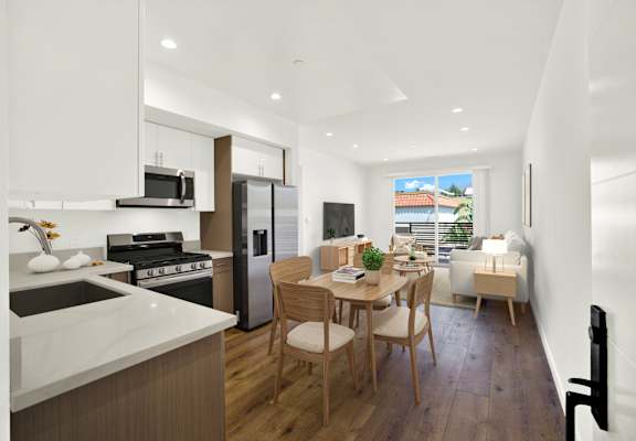 A modern kitchen with a dining table and chairs.