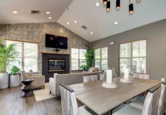 A modern dining room with a wooden table and chairs.