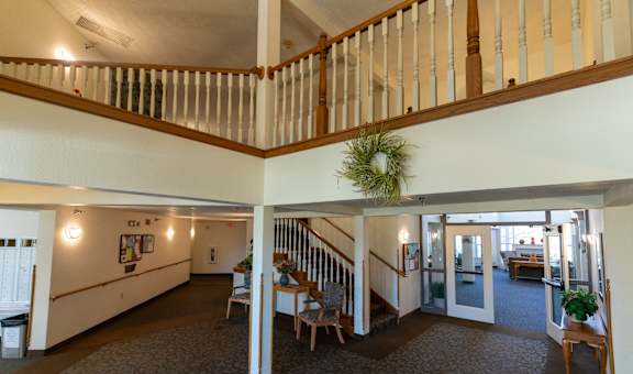 a view of therium of a building with a staircase and a dining room table