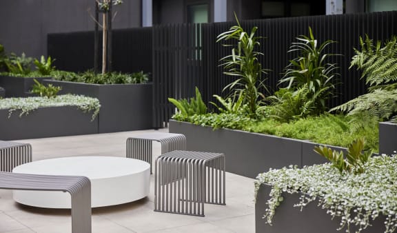 an outdoor seating area with tables and plants