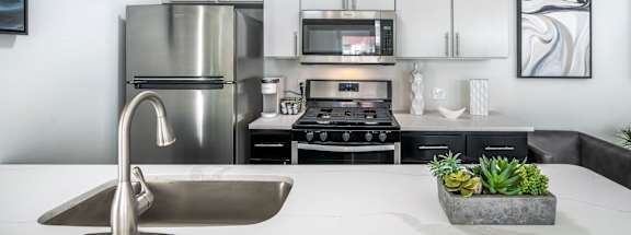 A modern kitchen with a stainless steel refrigerator, microwave, and oven.at Iris Luxury Apartments, Tennessee, 38105