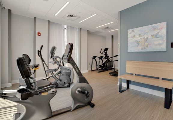 a room filled with exercise equipment and a bench