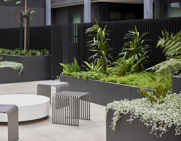 an outdoor seating area with tables and plants