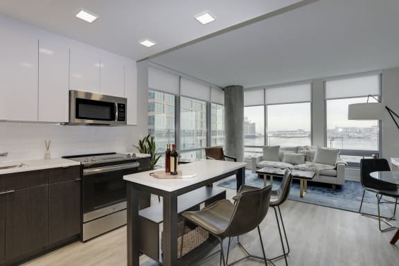 a kitchen and living room with a table and chairs