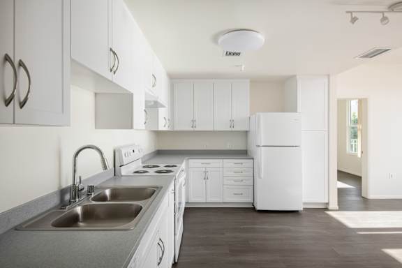 a kitchen with white cabinets and a sink