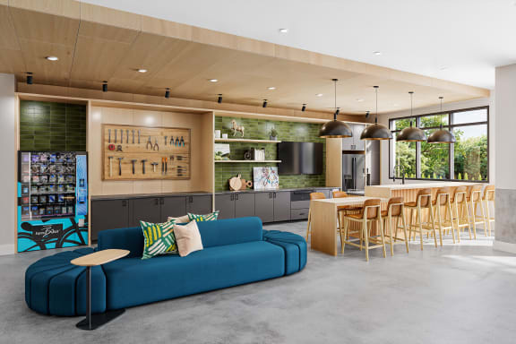 a living room with a blue couch and a kitchen with a table and chairs at Link Apartments® CYKEL Apartments, Charlotte , NC 28208