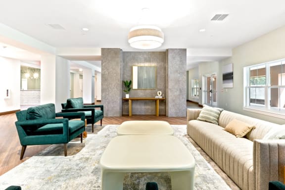 a living room with a couch and chairs and a table