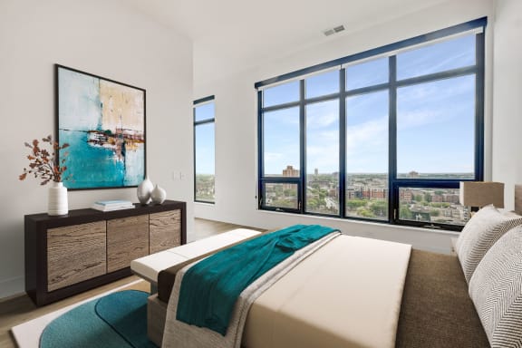 a bedroom with a bed and a large window