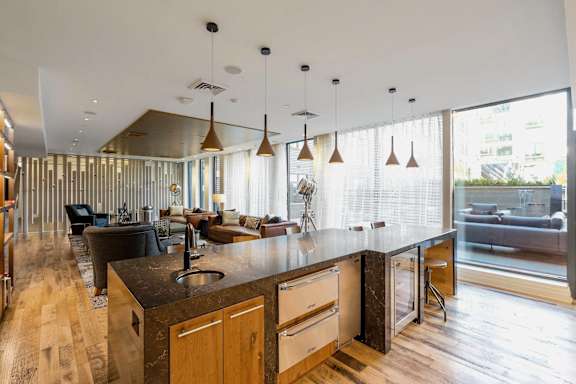 A modern kitchen with wooden cabinets and a large island.