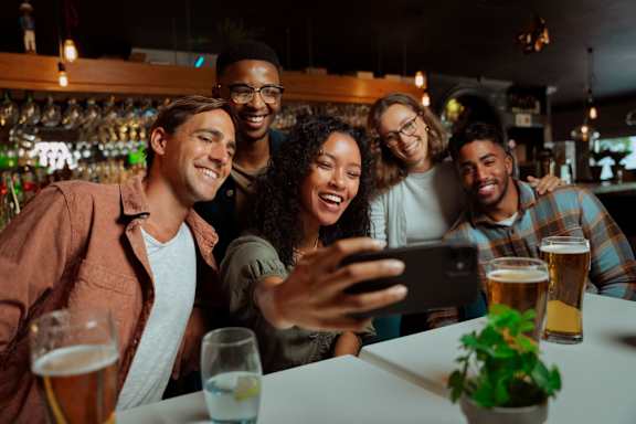A group of friends taking a selfie in a bar. at Grays Creek Apartments, Cordova, TN, 38018