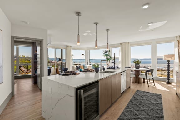 a rendering of a kitchen and living room with a view of the water