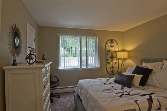 Furnished bedroom with lamp and window