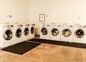 Thumbnail 7 of 8 - A row of washing machines in a laundromat.