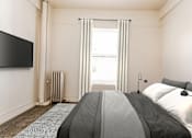 Thumbnail 3 of 8 - A bedroom with a large bed and a flat screen TV mounted on the wall.