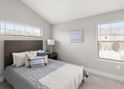 Thumbnail 3 of 11 - Spacious bedroom with two windows at Quarry Apartments and Townhomes in DeWitt, Michigan