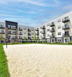 A sandy area in front of apartment buildings.