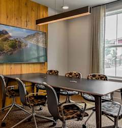 A conference room with a large table and chairs.