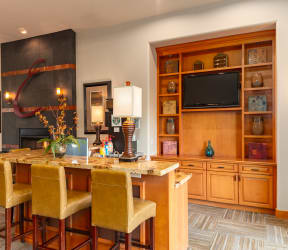 a kitchen with a large island with a marble countertop