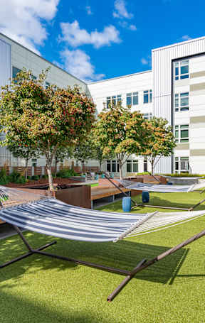 A modern building with a green lawn in front.