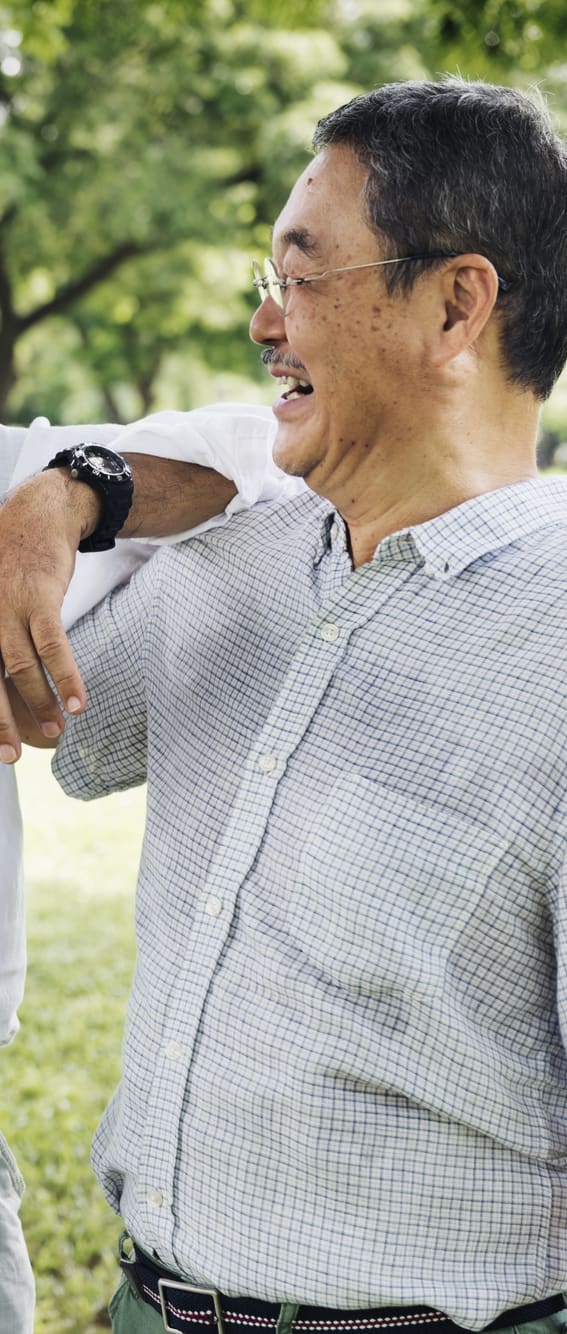 two men laughing in a park